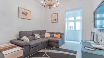 Apartment | Living area | 70-inch Smart TV with digital channels, streaming services