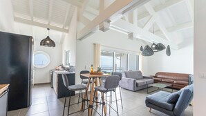 A modern living space with a kitchen, dining area, and seating area. - Only 4 View Rooftop Centre Sainte Anne (sainte anne)
