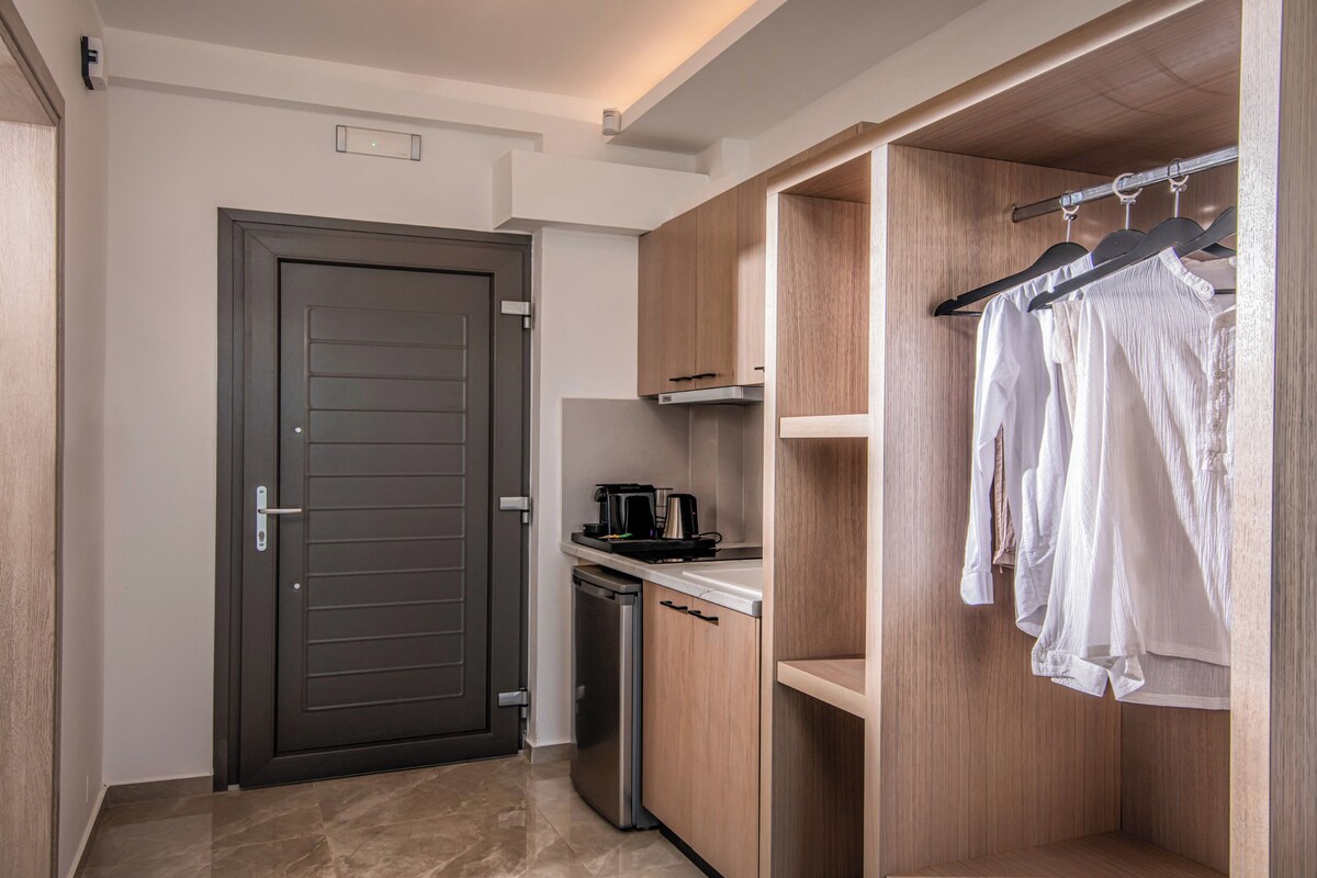 A modern kitchen with a coffee maker, a dishwasher, and wooden cabinets.