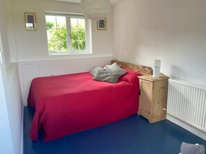 Cozy bedroom with a single bed, nightstand, and radiator.
