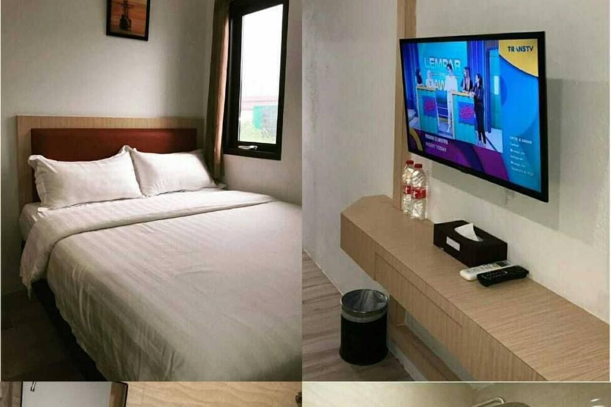 A hotel room with a bed, a TV, a bathroom with a sink, toilet, and shower.