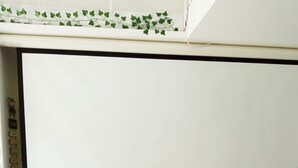 A room with a whiteboard, three black chairs with wooden legs, and a stone wall. - House surrounded by nature and relaxation for the whole family (Faveraye-Machelles)