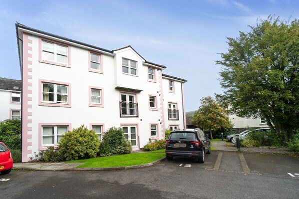 A multi-story residential building with pink-framed windows and balconies. - Greta Bank -  an apartment that sleeps 4 guests  in 2 bedrooms (Central Keswick)
