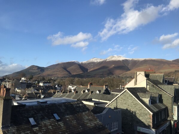 A town with buildings and a mountain in the background.