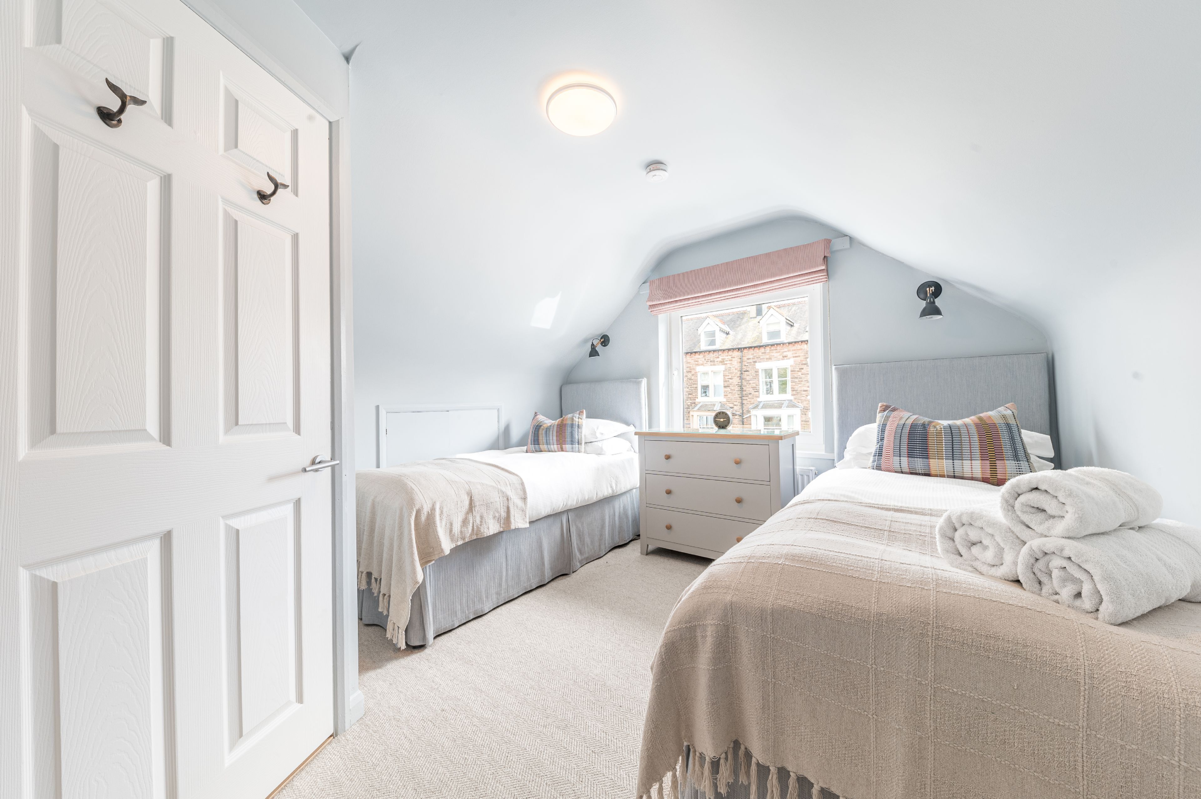 The room is furnished with 2 single beds, drawers and has hanging space for your clothes