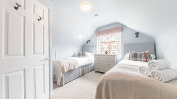 The room is furnished with 2 single beds, drawers and has hanging space for your clothes