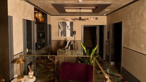 A modern lobby with a glass partition, a red chair, a ceiling fan, and a staircase. - Loly Boutique Hotel (Rome)