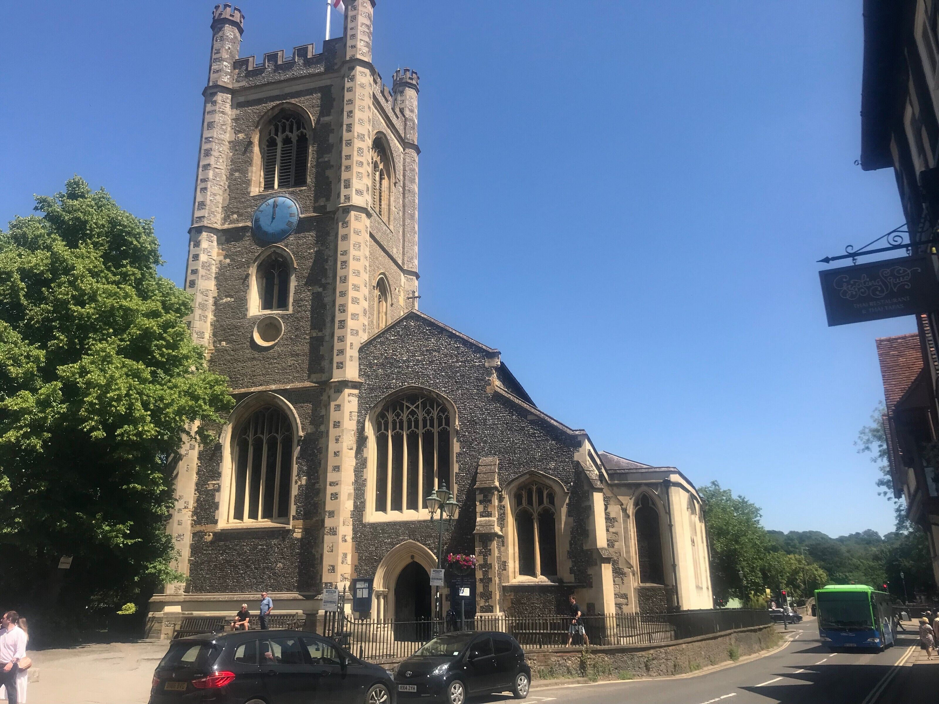 A historic church with a tall tower and large arched windows.