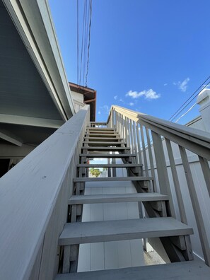 Staircase leads upwards with simple white railings.