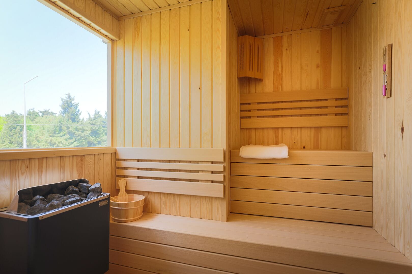 A wooden sauna with benches and a bench seat, a wooden bench, a wooden bench seat, and a sauna bench.