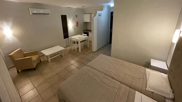A hotel room with a bed, a small desk, a chair, and a sofa. - CASA da PRAIA ALBUFEIRA PORTUGAL (Albufeira)