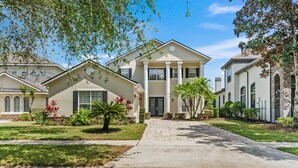 A residential building with a symmetrical facade, large windows, and a central entrance. - Homestead Laurel: Private Pool, Water Park, Golf View, Near Disney (Kissimmee)