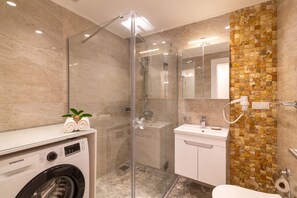 Bathtub, hair dryer, towels, soap