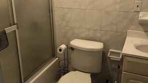 A small bathroom with a toilet, a shower, and a sink. - Close to JFK and Laguardia Air ports (Queens)