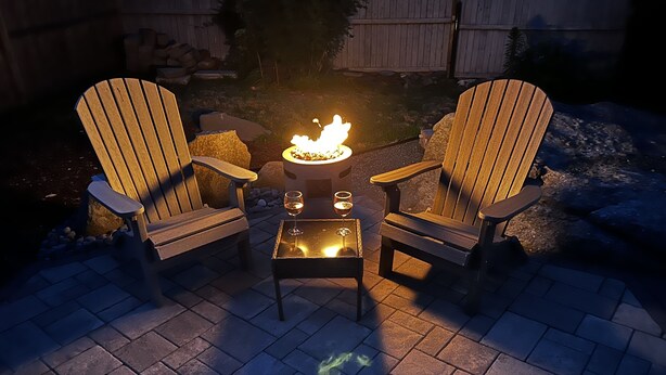 Two Adirondack chairs with a small table and a fire pit between them. - Remodeled Jamestown beach cottage within walking distance to beach (Jamestown)