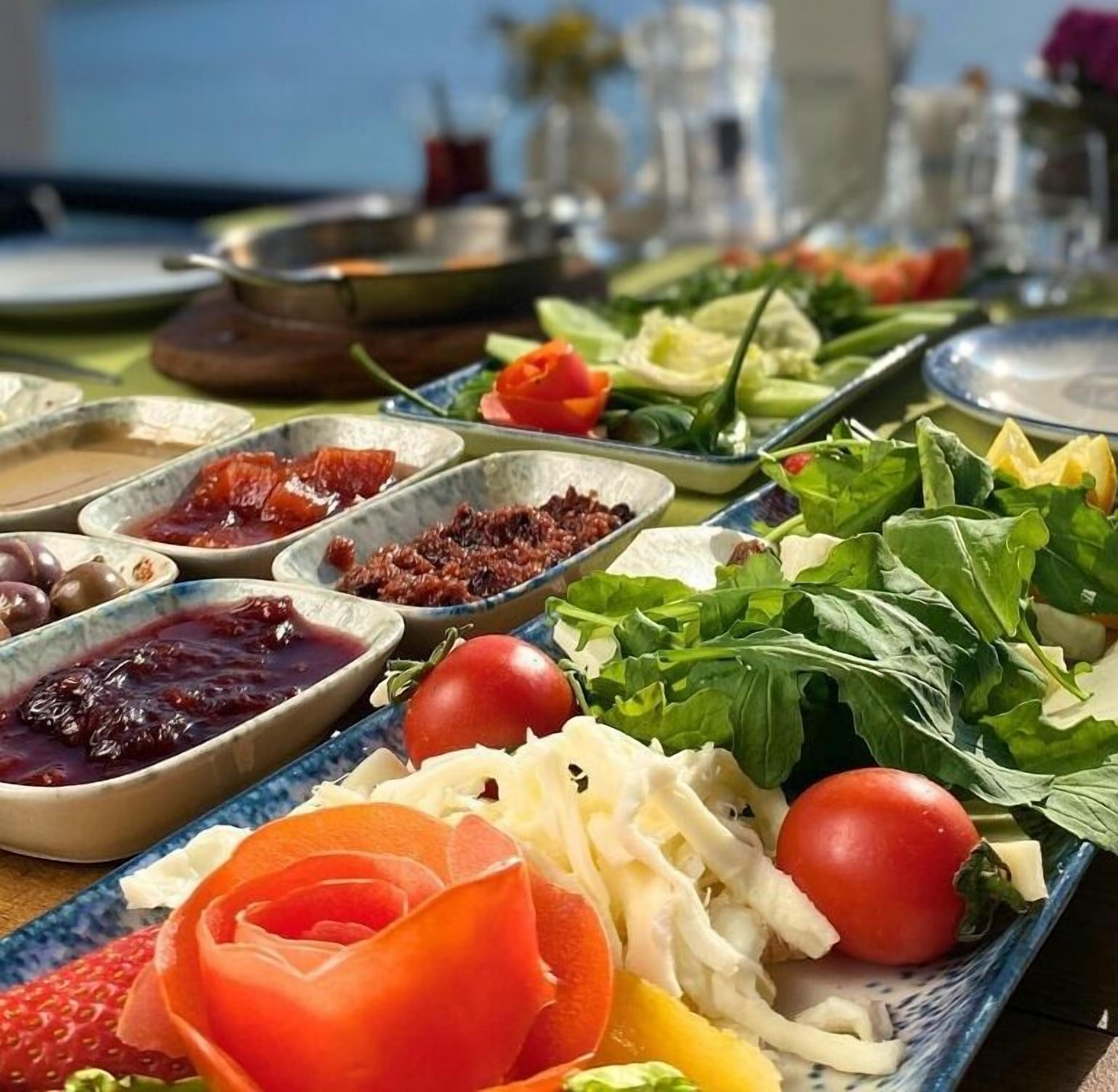 A table with various food items including fruits, vegetables, and condiments.