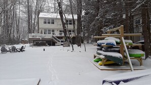 A snow-covered outdoor area with a wooden deck and sleds. - Lakefront • Hot Tub • Private Dock • Kayaks • Canoe • Fire Pit • Dog Friendly (Coolbaugh Township)