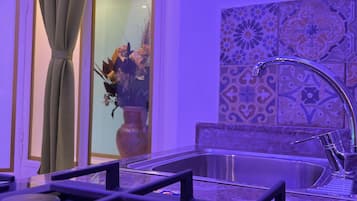 Deluxe Condo | Private kitchen | Full-sized fridge, stovetop, coffee/tea maker, cleaning supplies