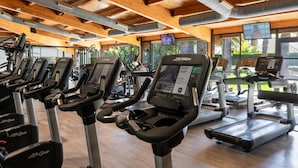 A gym with multiple treadmills, exercise bikes, and a variety of fitness equipment. - Oassium Hotel at Estival Park (Vila-Seca)