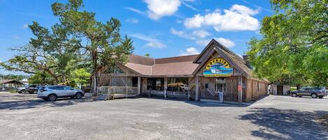 A rustic building with a sign reading "Dockside Seafood House Established 1953".