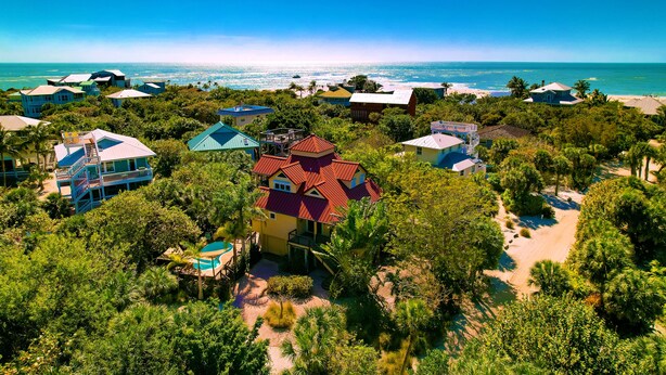 A coastal resort with multiple buildings, a swimming pool, and a beach view. - The Salty Conch - Luxury Just Steps To The Beach with Private Pool;2 Golf Carts (Captiva)