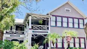 A two-story building with a balcony, a porch, and a sign indicating it is a bed and breakfast. - Old Powder House Inn (St. Augustine)