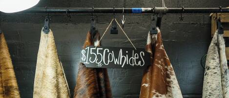 A display of fur pelts hanging on a rack.