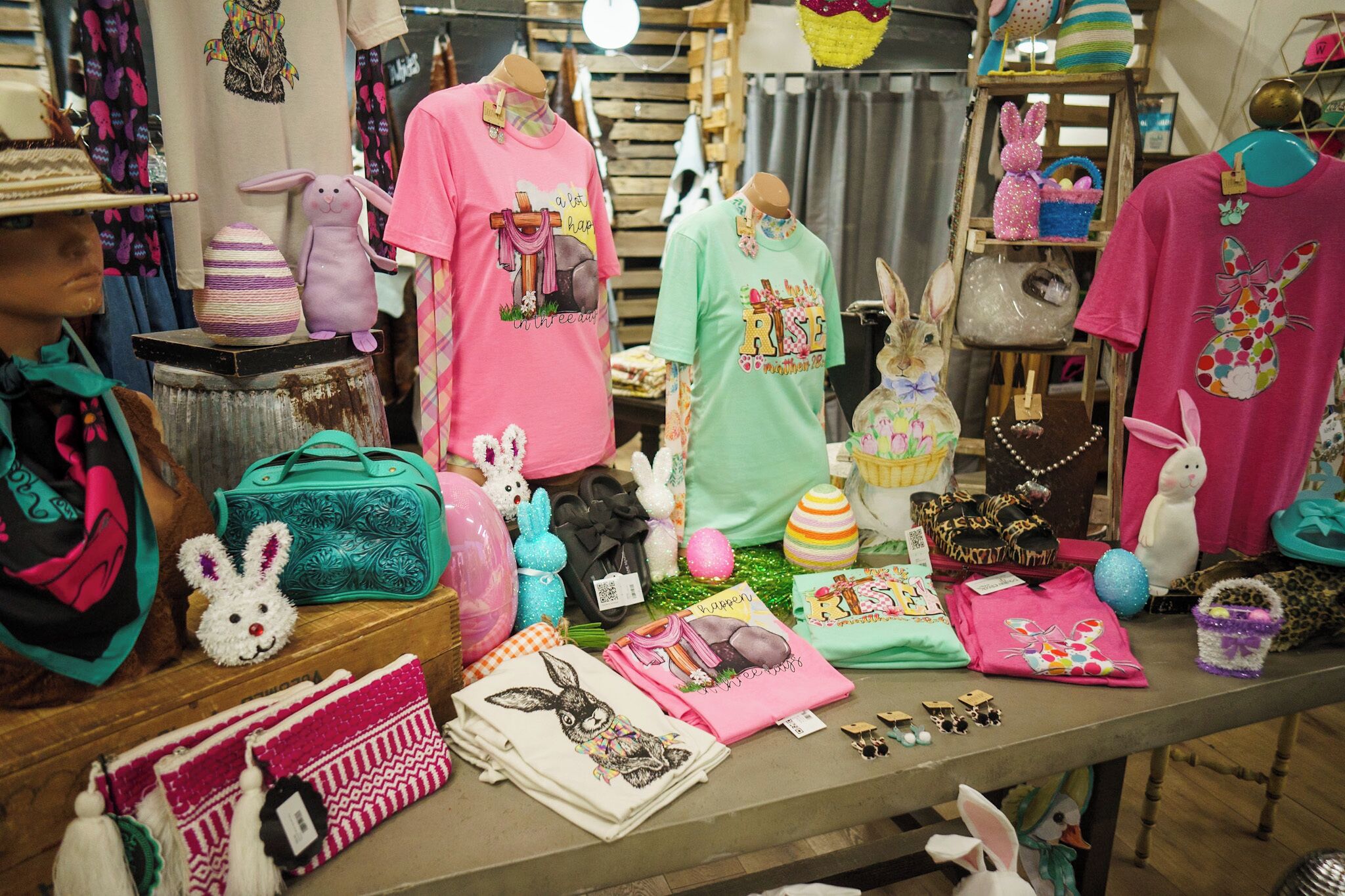 A display of Easter-themed merchandise including plush toys, bags, and clothing.