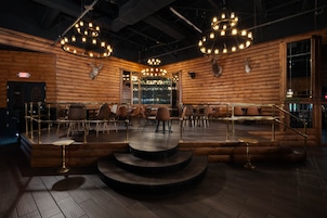 A spacious, modern lounge area with tiered seating and a wooden interior.