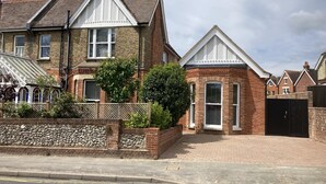 A residential area with houses featuring brick facades, pitched roofs, and white window frames. - Self-contained annex close to town centre (Eastbourne)