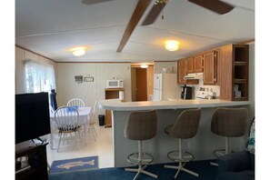 Enjoy a fully equipped kitchenette with a dining area and bar, perfect for preparing and serving meals.