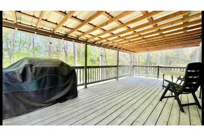 Enjoy al fresco dining on this outdoor deck with a barbecue grill and comfortable seating.