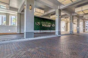 A spacious lobby with a green wall displaying the text "laketown WHARF" and a fish logo.