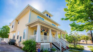 A two-story house with a front porch, a small garden, and a staircase leading to the entrance. - Chesapeake Chalet- Cozy,Close to Hard Rock and All (Atlantic City)
