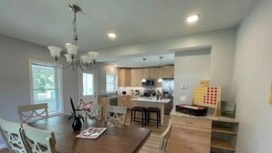 Une cuisine moderne avec des meubles en bois, un îlot central et des luminaires suspendus.