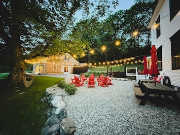 Gather outside to enjoy the fire pit, hot tub, corn hole and barn game room.