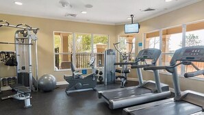 A gym with treadmills, weight machines, and exercise balls. - TOP-RATED WINDSOR HILLS Private Home ♥ Pool/Spa, GAME ROOM ♥ 4 mi to DISNEY (Kissimmee)