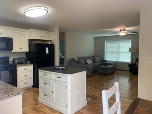 A compact living space with a kitchen, dining area, and seating area.