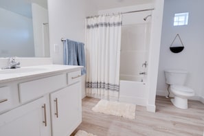 Combined shower/bathtub, hair dryer, towels, toilet paper