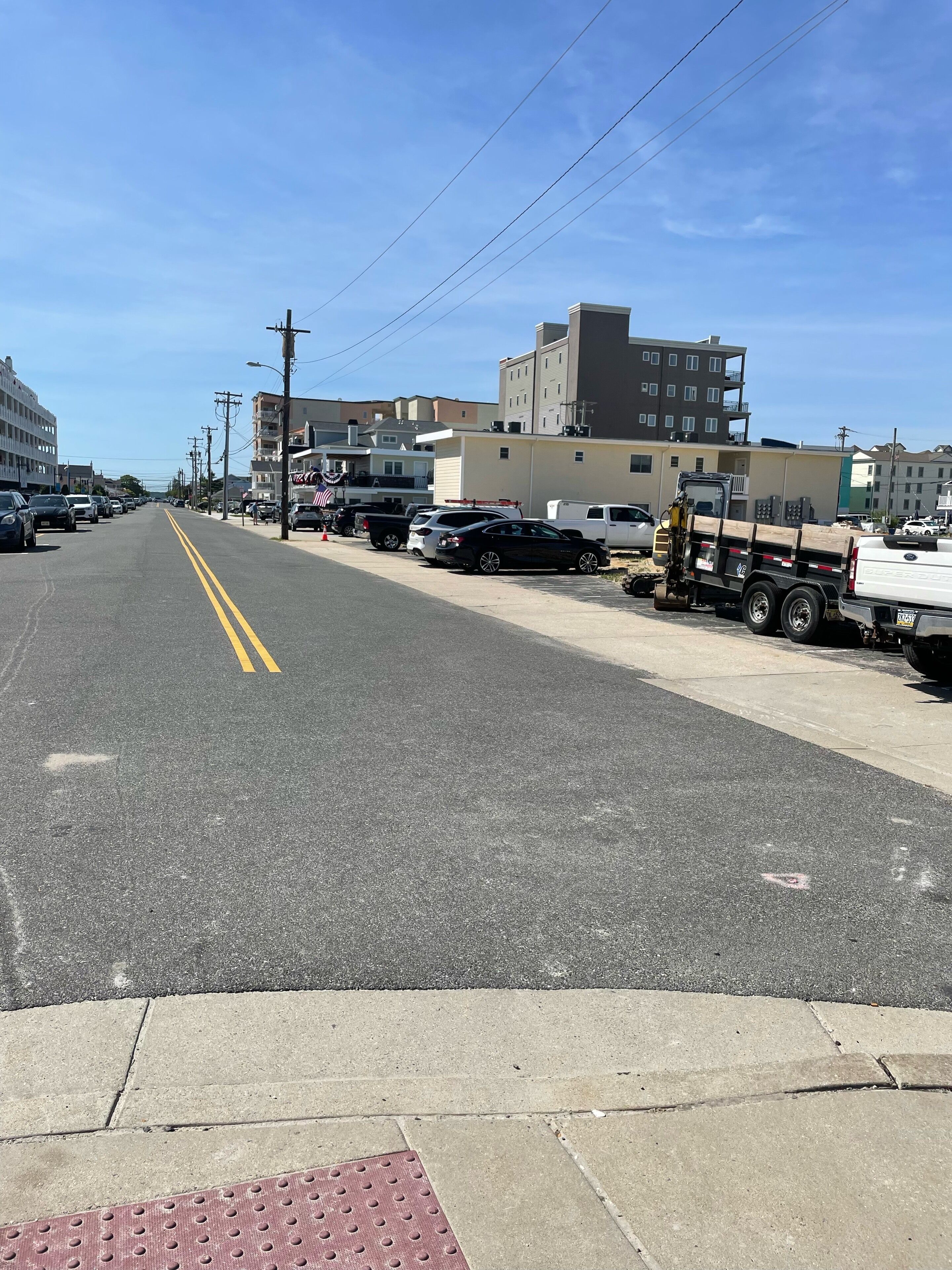 A street with parked cars and buildings.