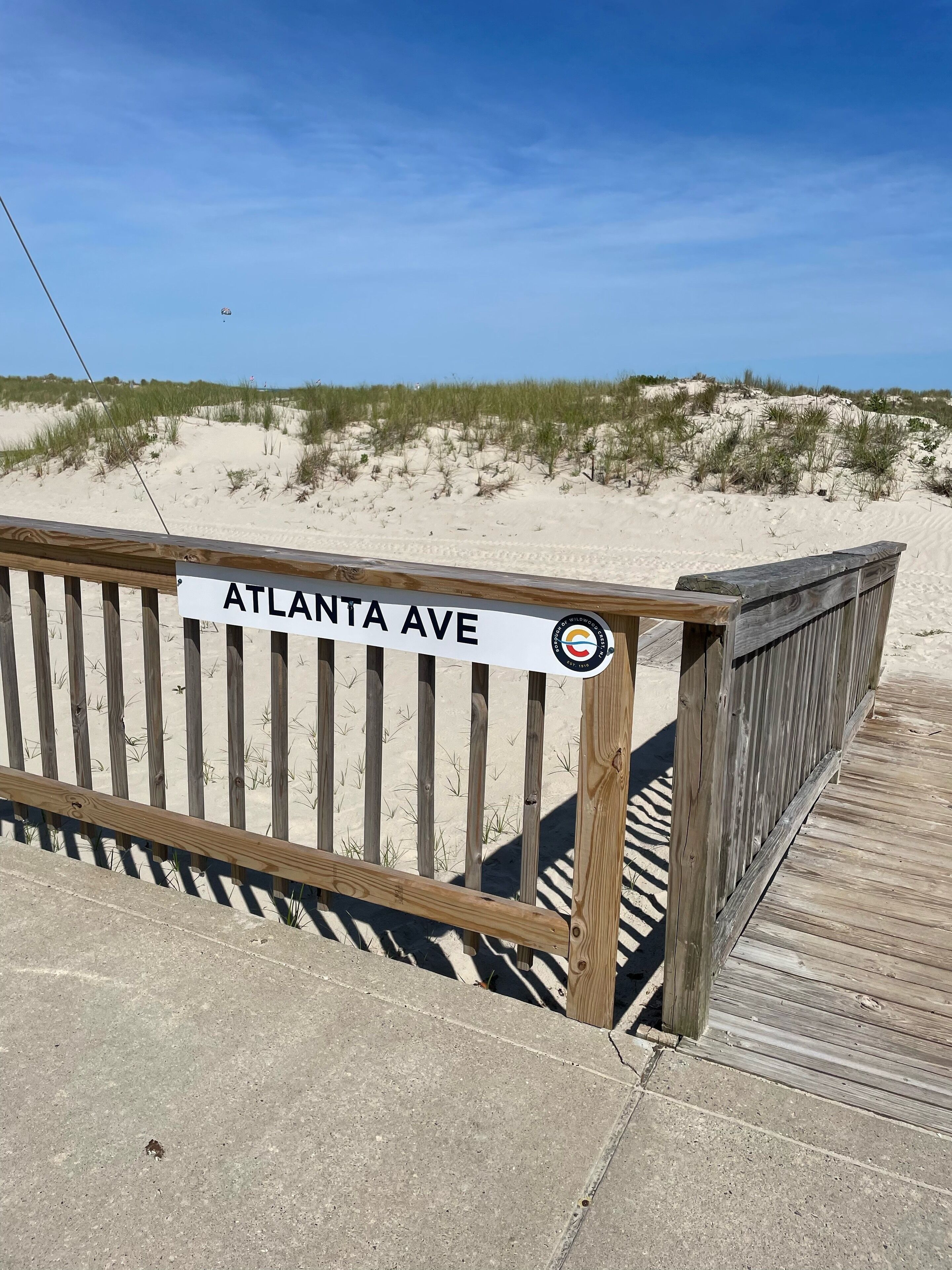 A wooden boardwalk with a sign reading 'ATLANTA AVE.'