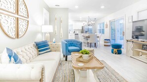 A modern living room with a sofa, a blue armchair, a wooden coffee table, and a TV cabinet. - Your adventure at the Lake. 9 Mi from the Ark Encounter, breathtaking view. (Dry Ridge)