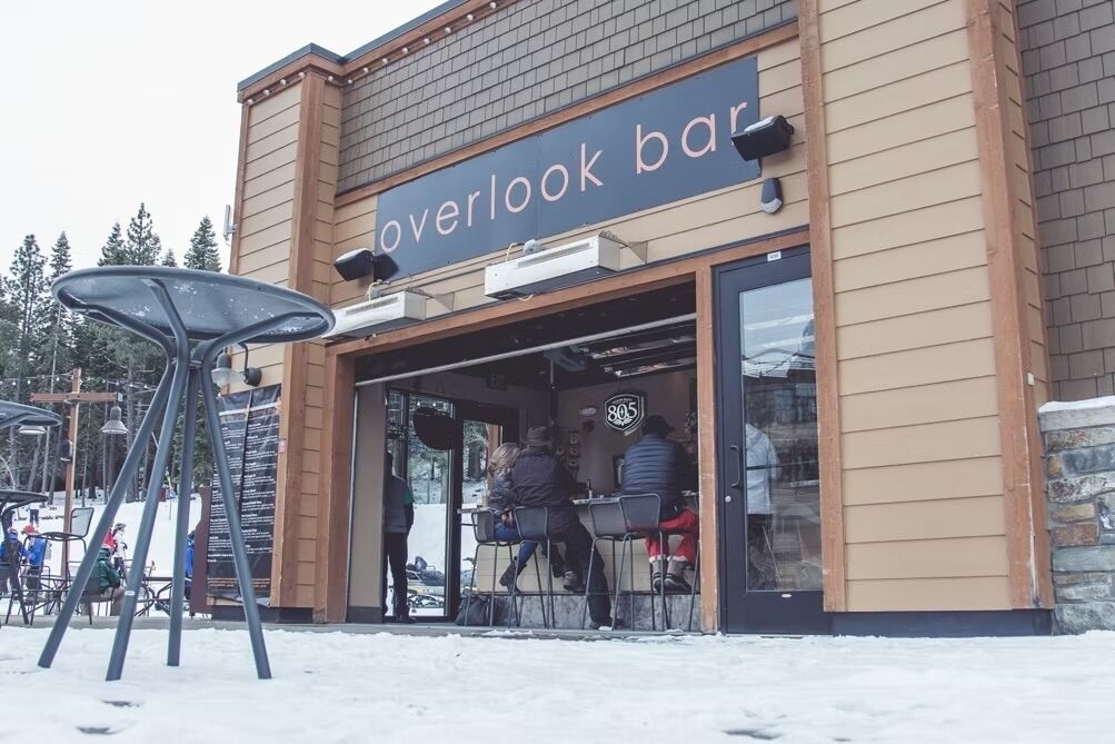 An overlook bar with a wooden facade and large windows.