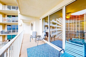 Enjoy the view from your balcony overlooking the pool area with a glass barrier.
