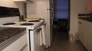 A kitchen with a stove, oven, and refrigerator. - Home away from home! (Decatur)