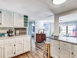 Enjoy meals in the kitchen, which offers a dining area with a table and chairs.