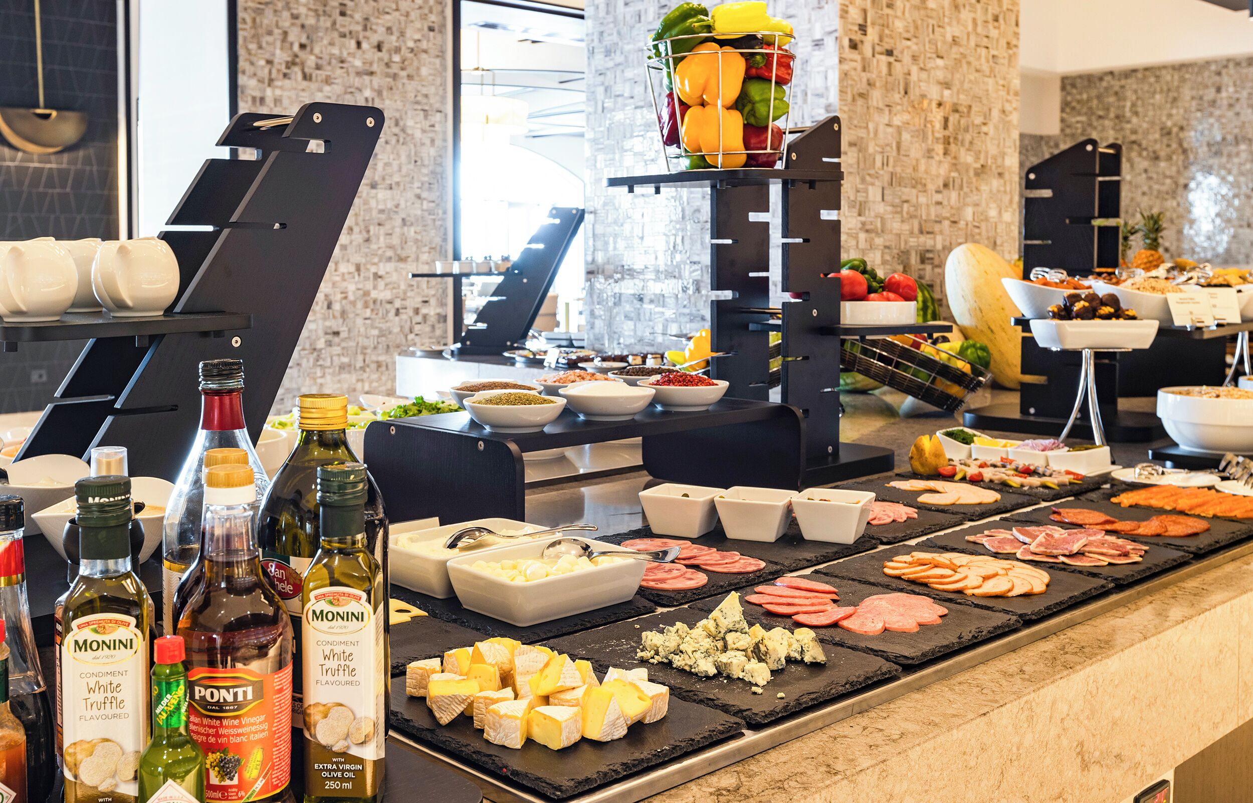 A buffet with various food items and condiments.
