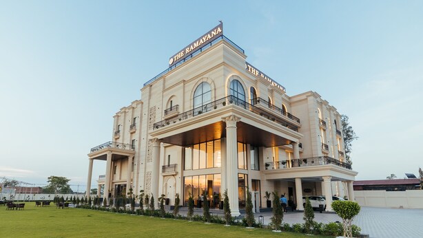 A large, multi-story hotel with a prominent sign reading "THE RAMAYANA". - The Ramayana Hotel Ayodhya (Faizabad)