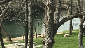 A park with a lake, trees, and picnic tables. - 2/2 Condo Directly on the Guadalupe River with Beautiful Canyon Views (New Braunfels)