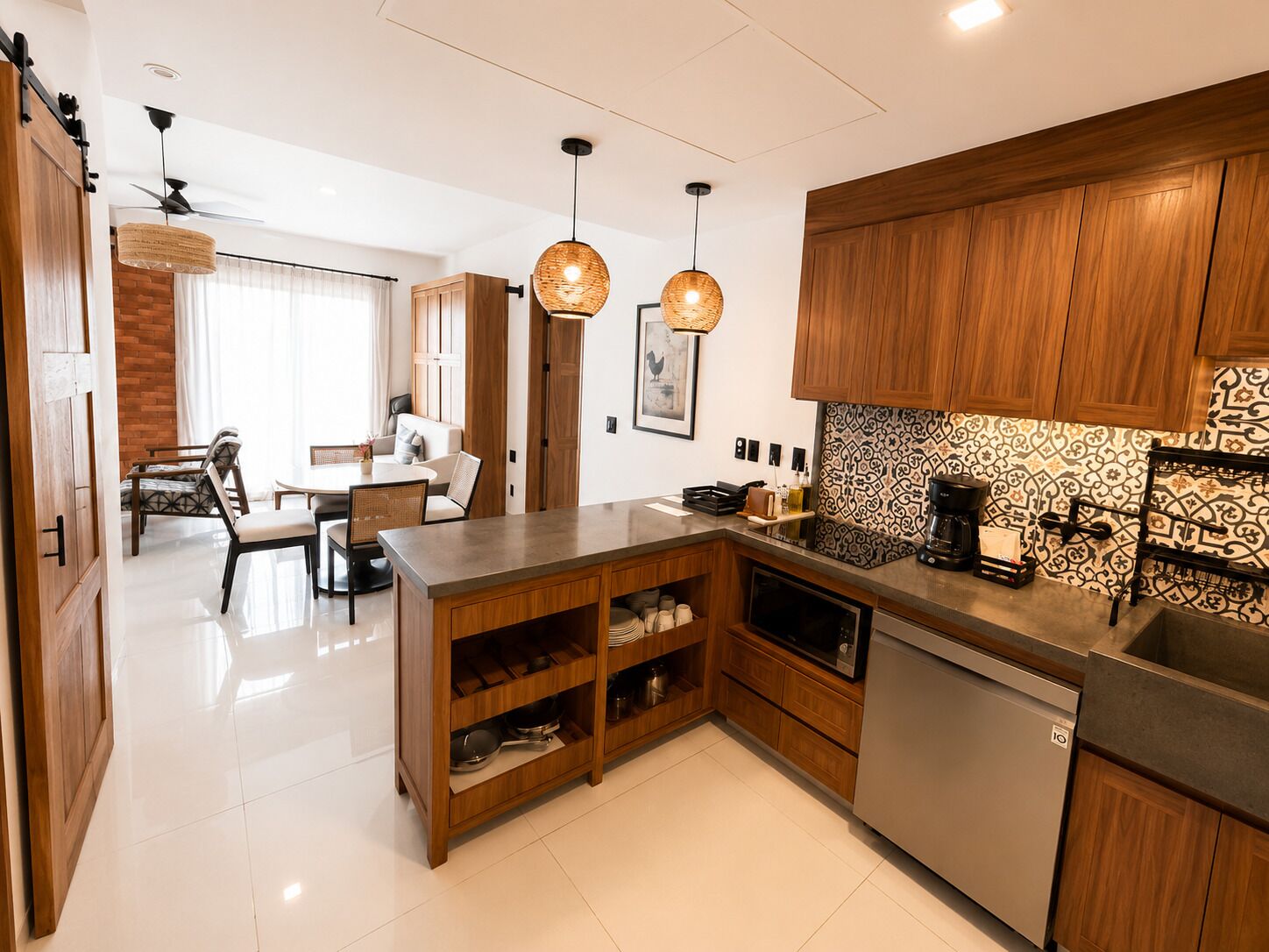 A modern kitchen with wooden cabinets, a built-in oven, and a coffee maker.